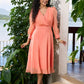 Graceful peach organza dress highlighted with pearl work