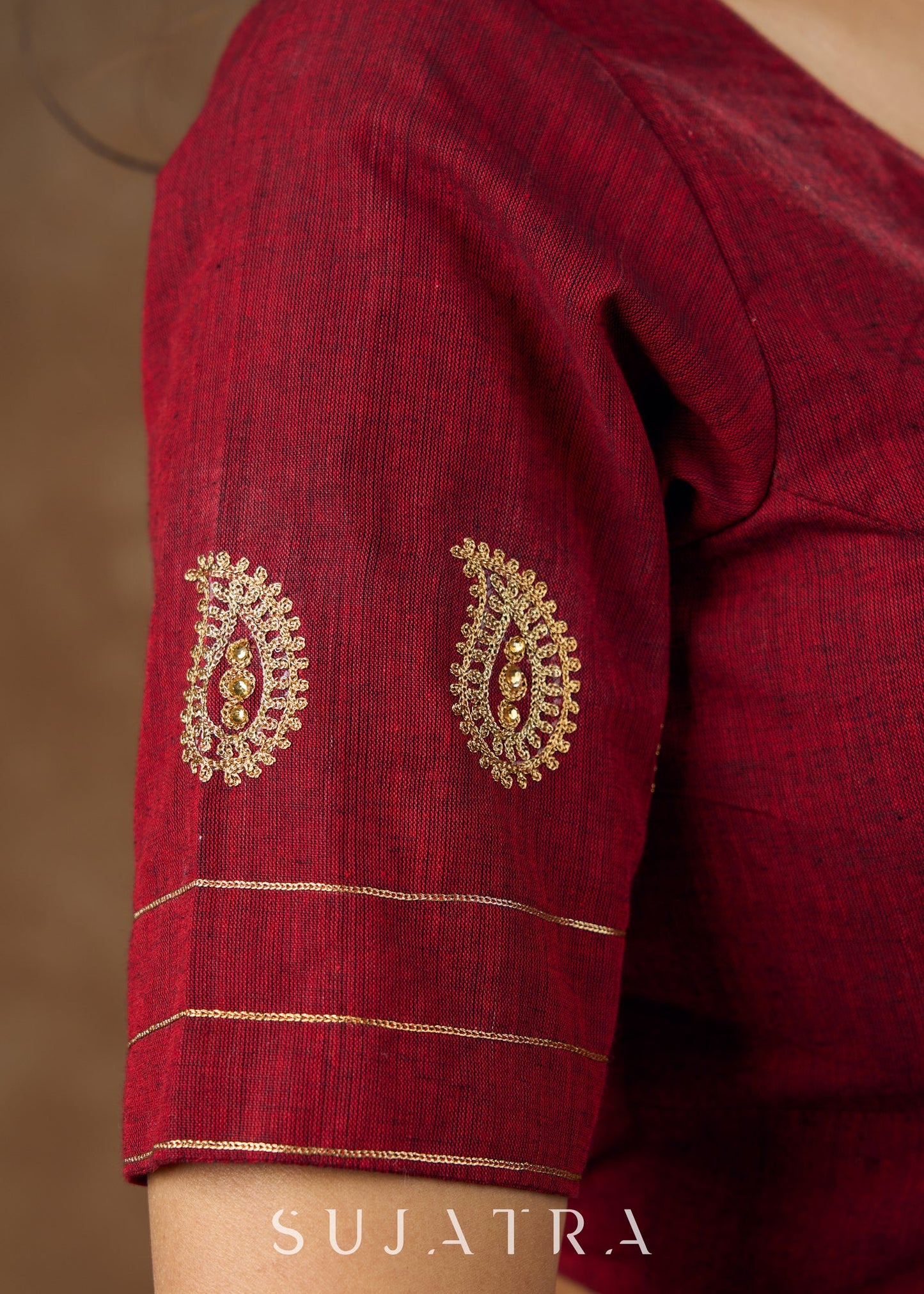 Real elegance : Maroon cotton blouse featuring intricate phaisley embroidery perfect for making a sophisticated statement