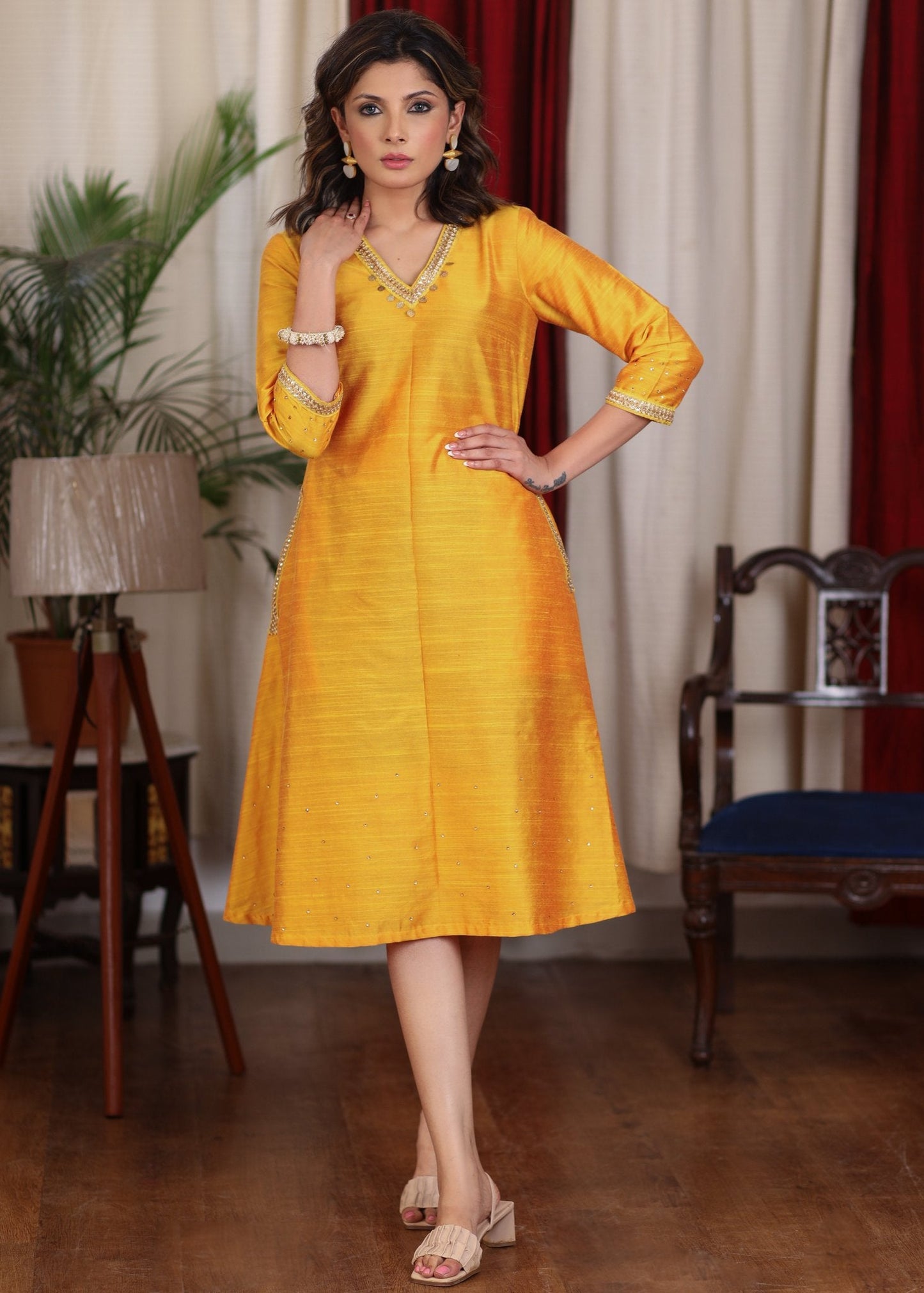 Beautiful mango cotton silk dress with pockets highlighted with zari lace and coin embellishments