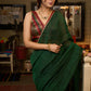 Trendy bottle green cotton saree highlighted with golden lace