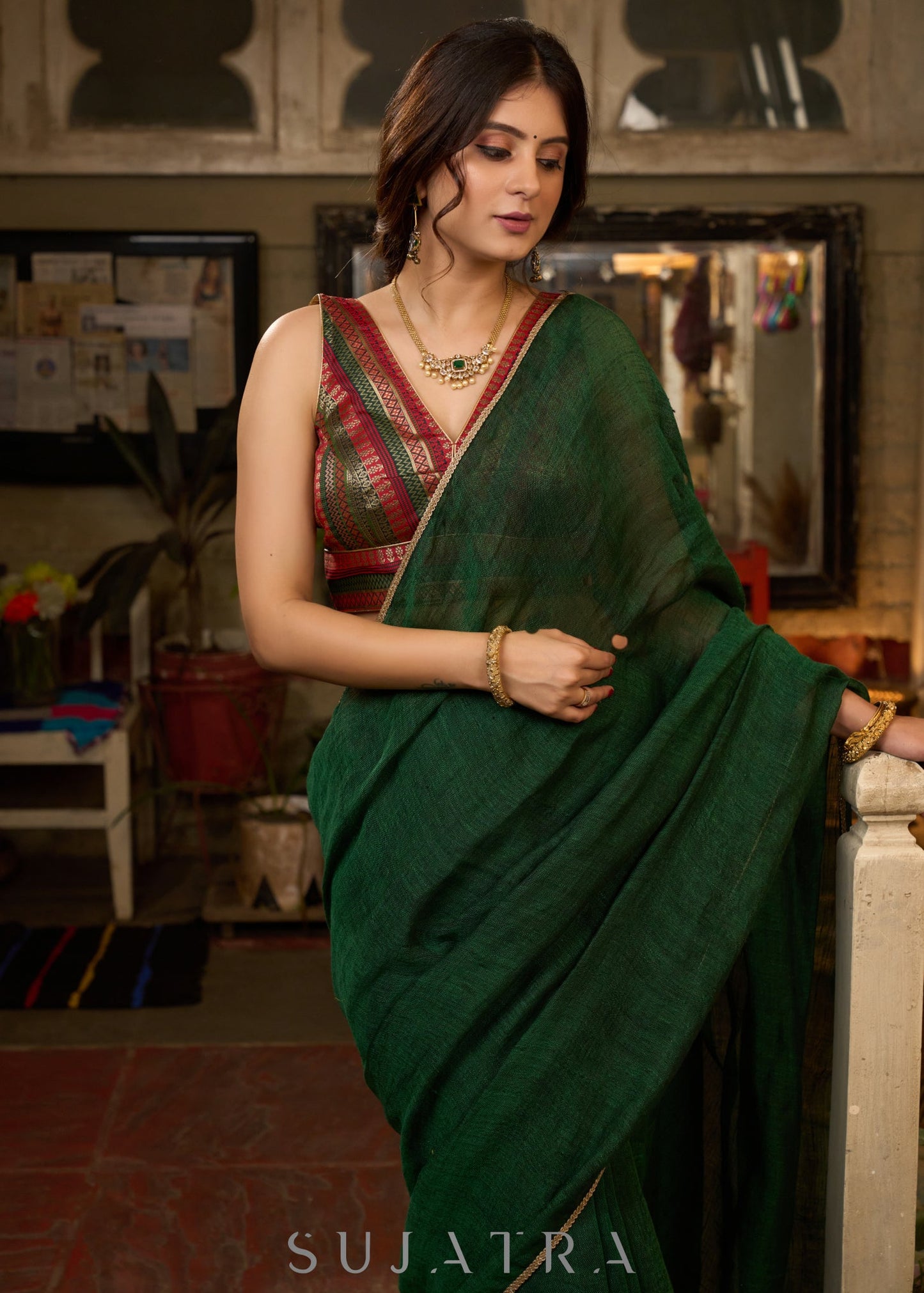 Trendy bottle green cotton saree highlighted with golden lace