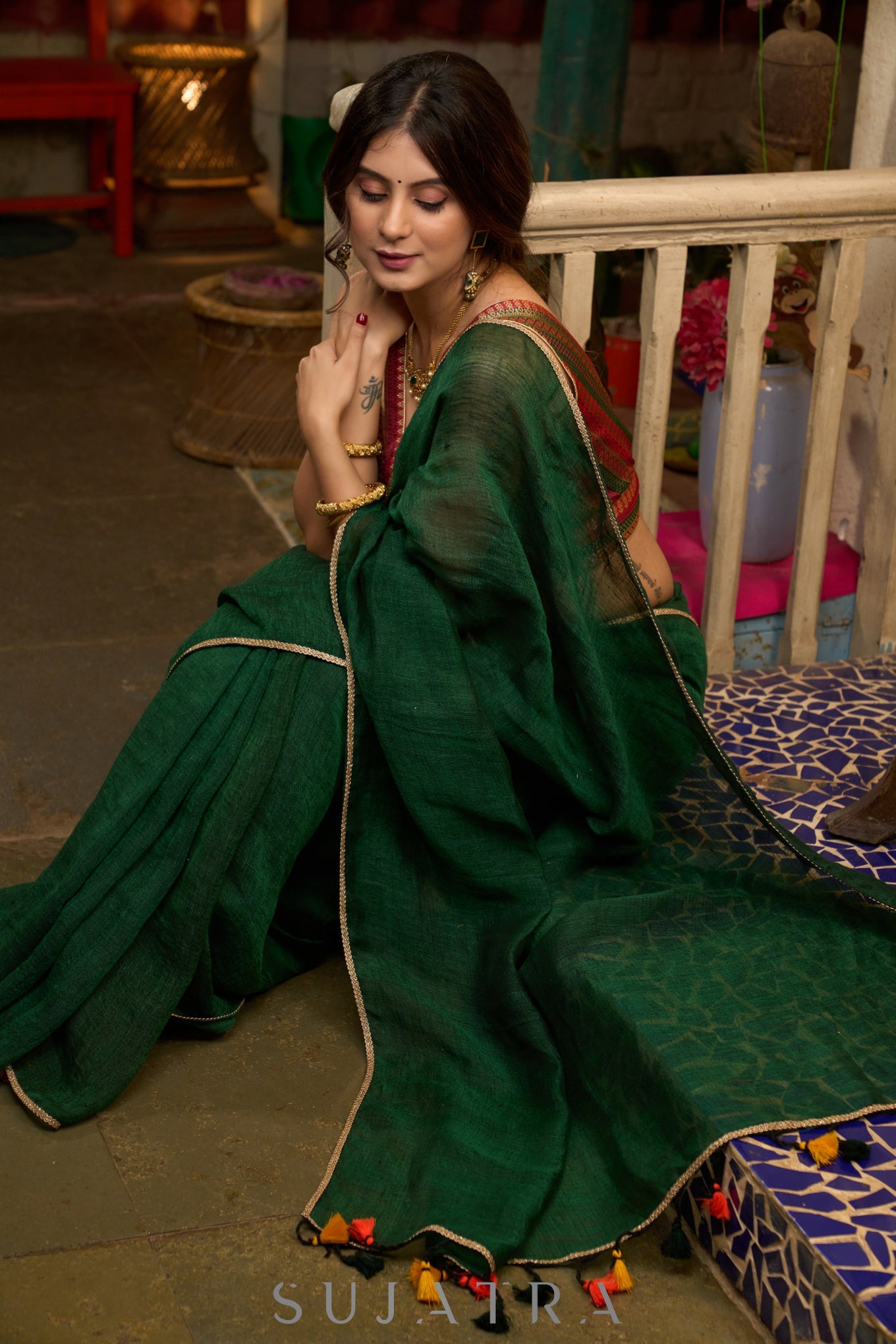 Trendy bottle green cotton saree highlighted with golden lace