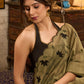 Elegant dark olive green cotton saree highlighted with floral applique and overall scallops