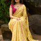 Graceful yellow floral print saree highlighted with overall beautiful hand embroidered mirrors