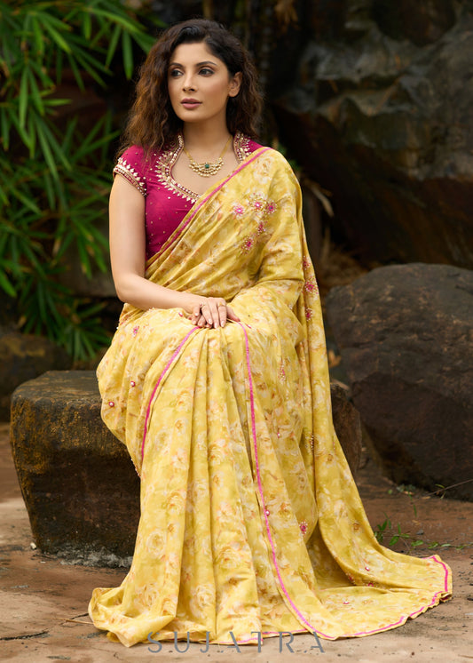 Graceful yellow floral print saree highlighted with overall beautiful hand embroidered mirrors