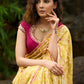 Graceful yellow floral print saree highlighted with overall beautiful hand embroidered mirrors