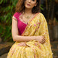 Graceful yellow floral print saree highlighted with overall beautiful hand embroidered mirrors