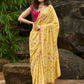 Graceful yellow floral print saree highlighted with overall beautiful hand embroidered mirrors