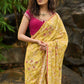 Graceful yellow floral print saree highlighted with overall beautiful hand embroidered mirrors