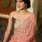 Luscious peach organza saree with beautiful floral hand embroidey and overall scallops