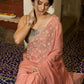 Luscious peach organza saree with beautiful floral hand embroidey and overall scallops