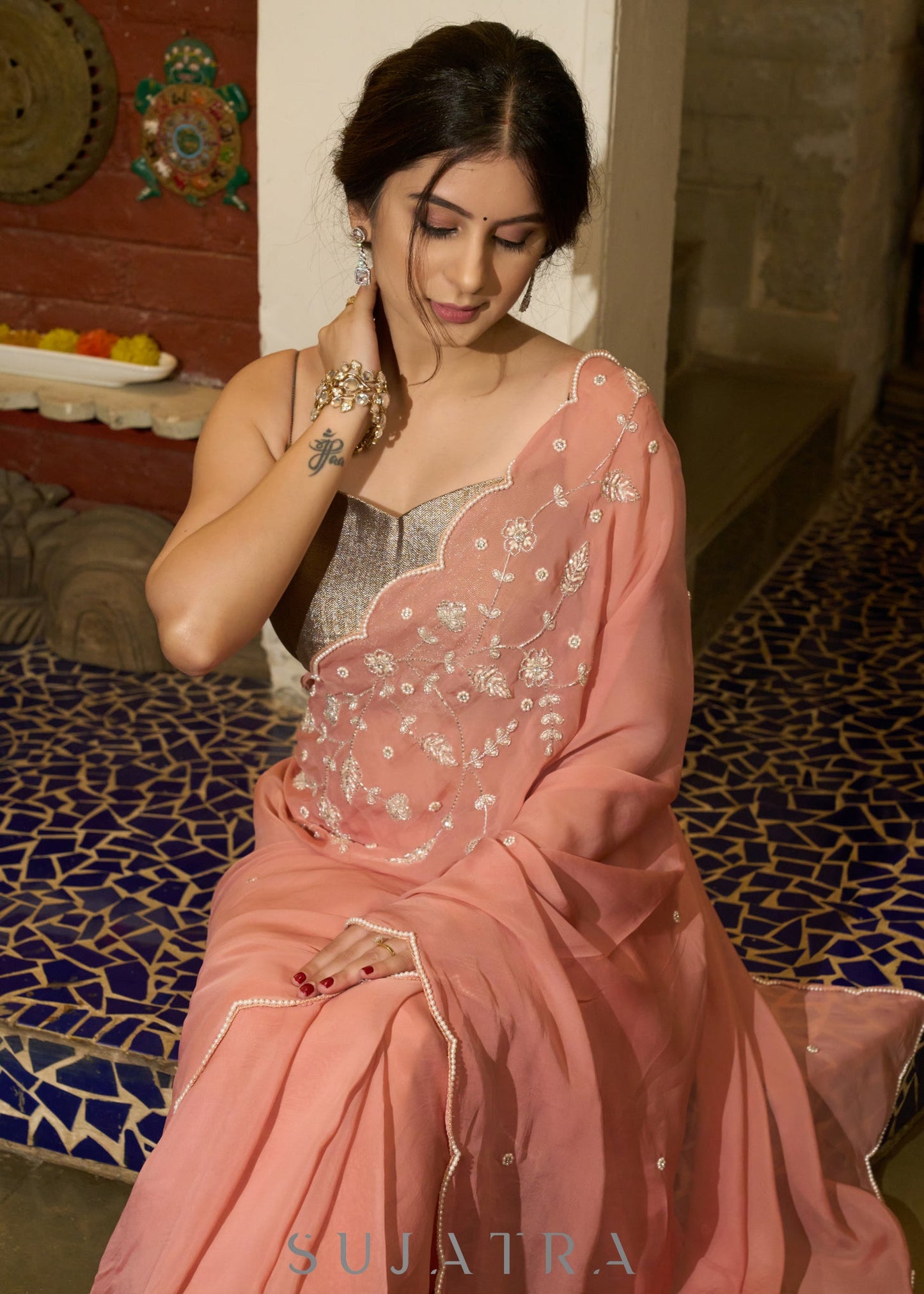 Luscious peach organza saree with beautiful floral hand embroidey and overall scallops