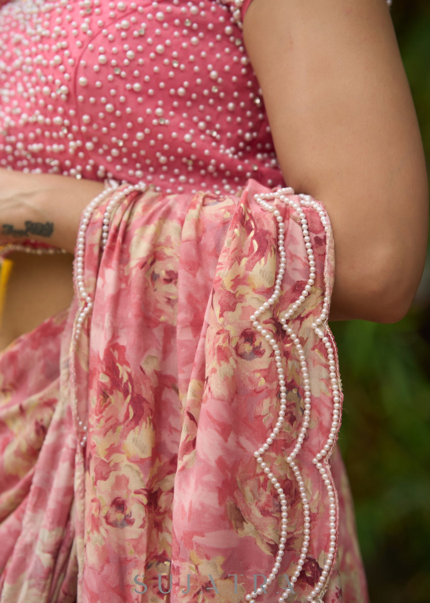 Beautiful blush pink floral saree highlighted with overall pearl embroidery