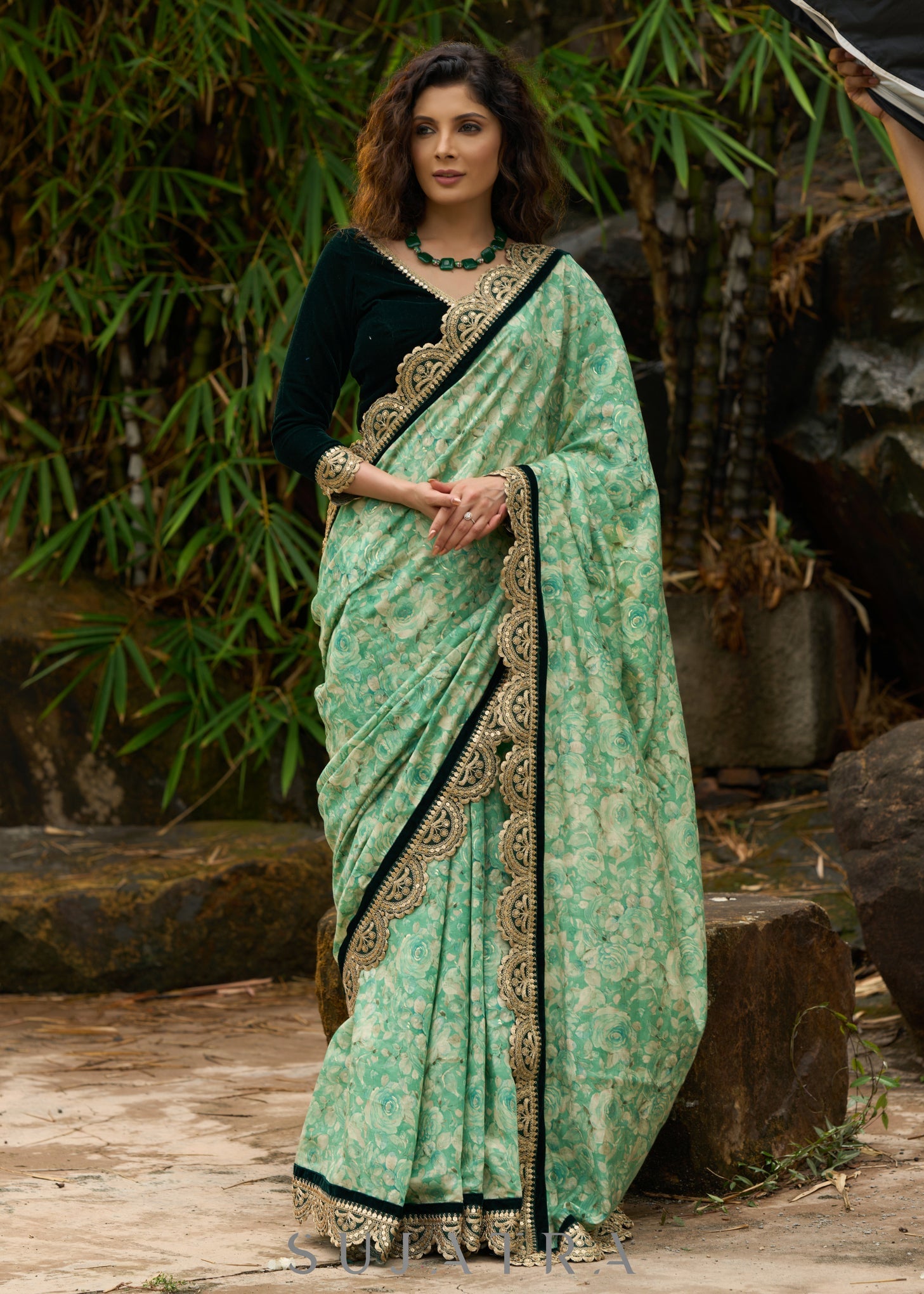 Elegant Emerald green floral printed saree highlighted with bottle green velvet & contrast scalloped lace