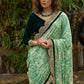 Elegant Emerald green floral printed saree highlighted with bottle green velvet & contrast scalloped lace