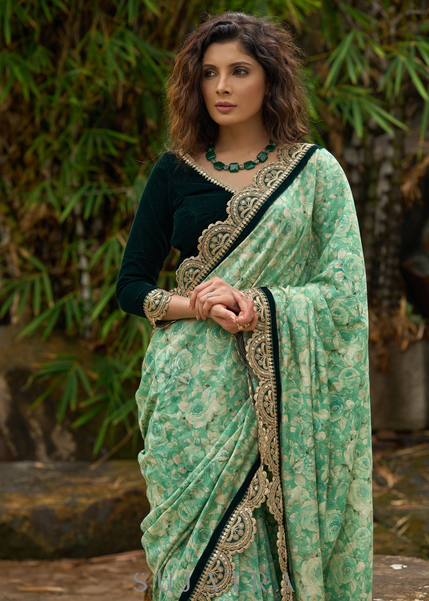 Elegant Emerald green floral printed saree highlighted with bottle green velvet & contrast scalloped lace