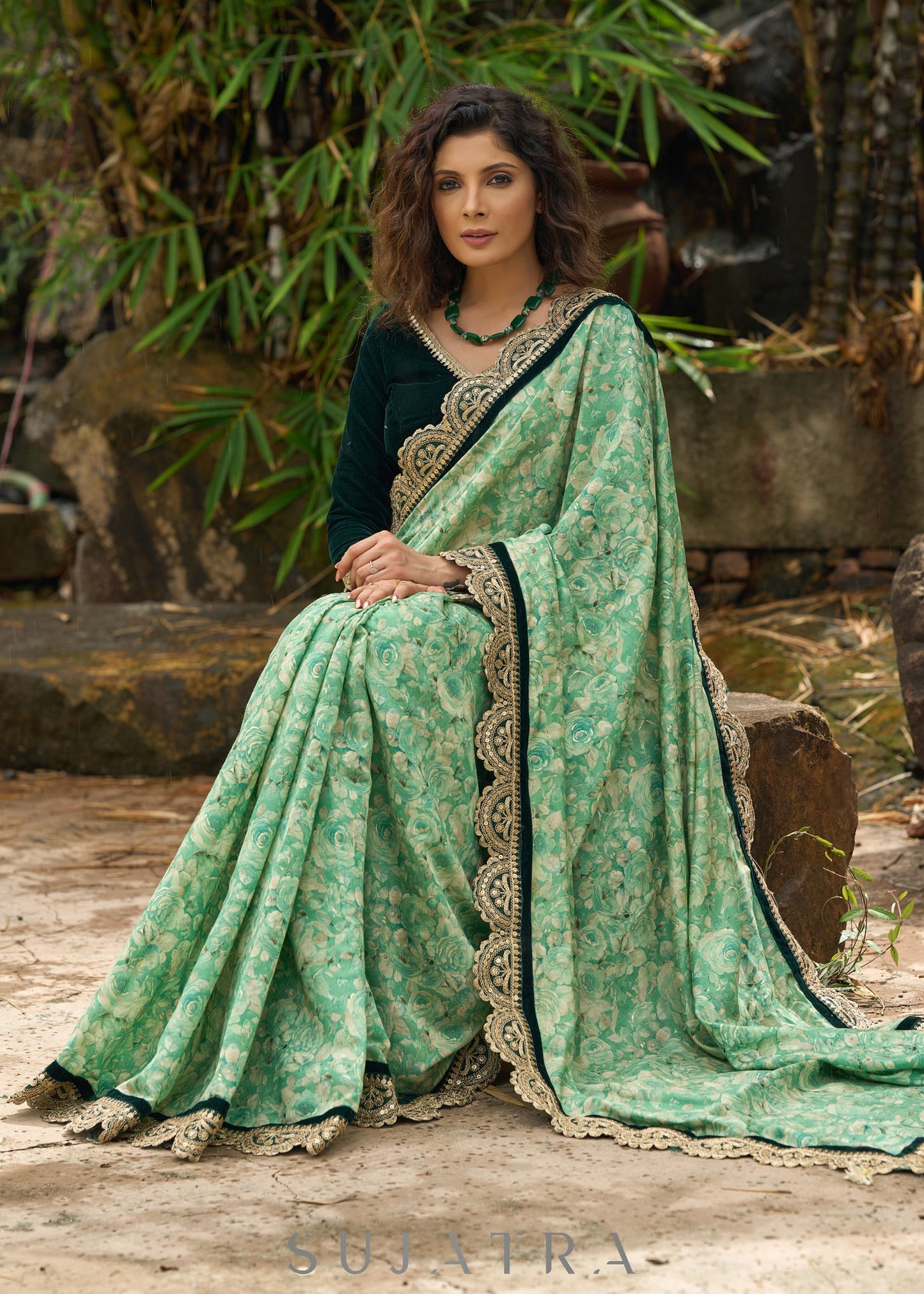 Elegant Emerald green floral printed saree highlighted with bottle green velvet & contrast scalloped lace