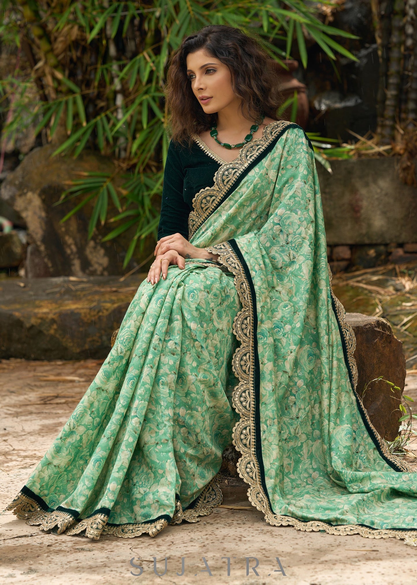 Elegant Emerald green floral printed saree highlighted with bottle green velvet & contrast scalloped lace