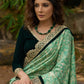 Elegant Emerald green floral printed saree highlighted with bottle green velvet & contrast scalloped lace