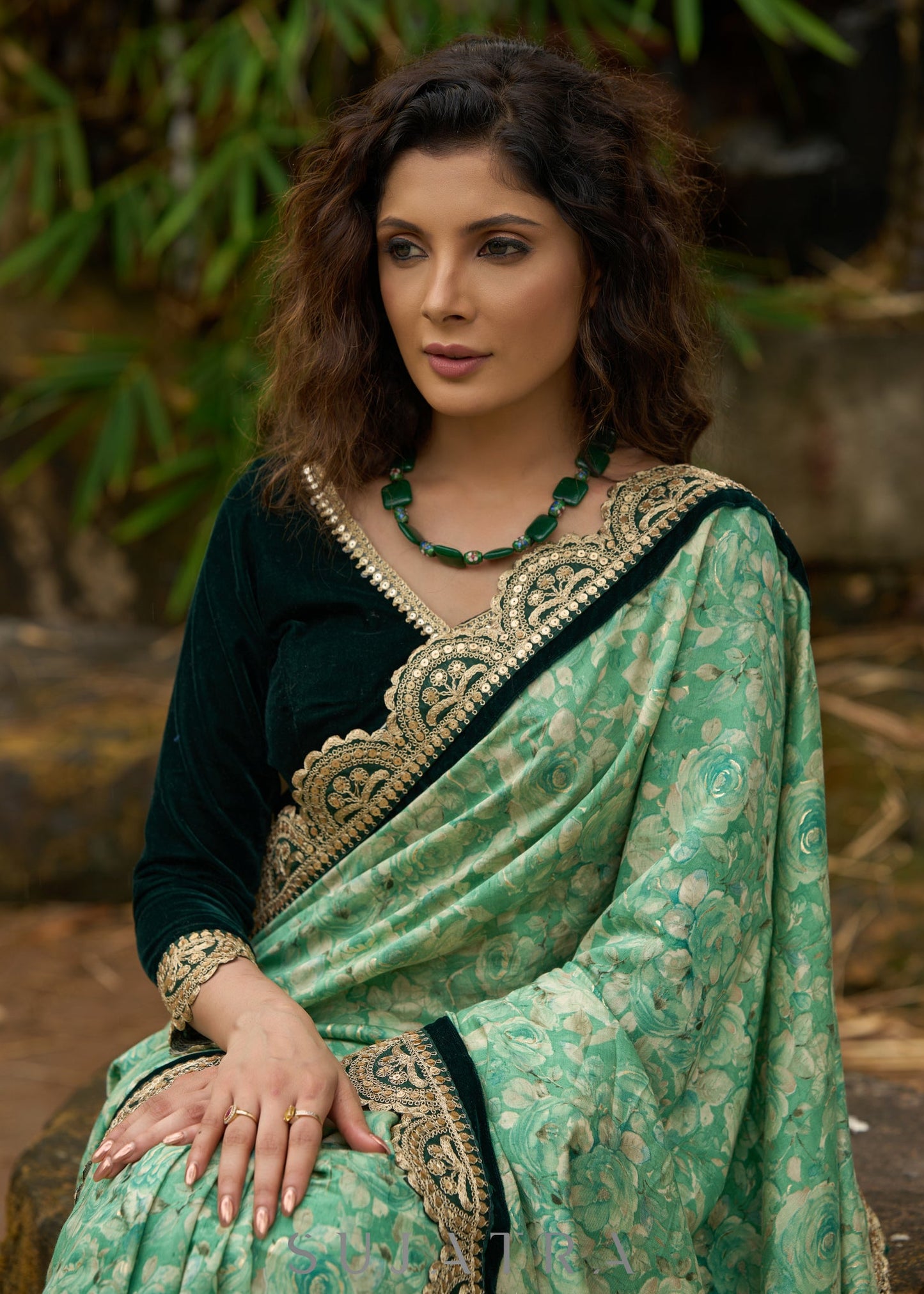 Elegant Emerald green floral printed saree highlighted with bottle green velvet & contrast scalloped lace