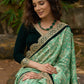 Elegant Emerald green floral printed saree highlighted with bottle green velvet & contrast scalloped lace