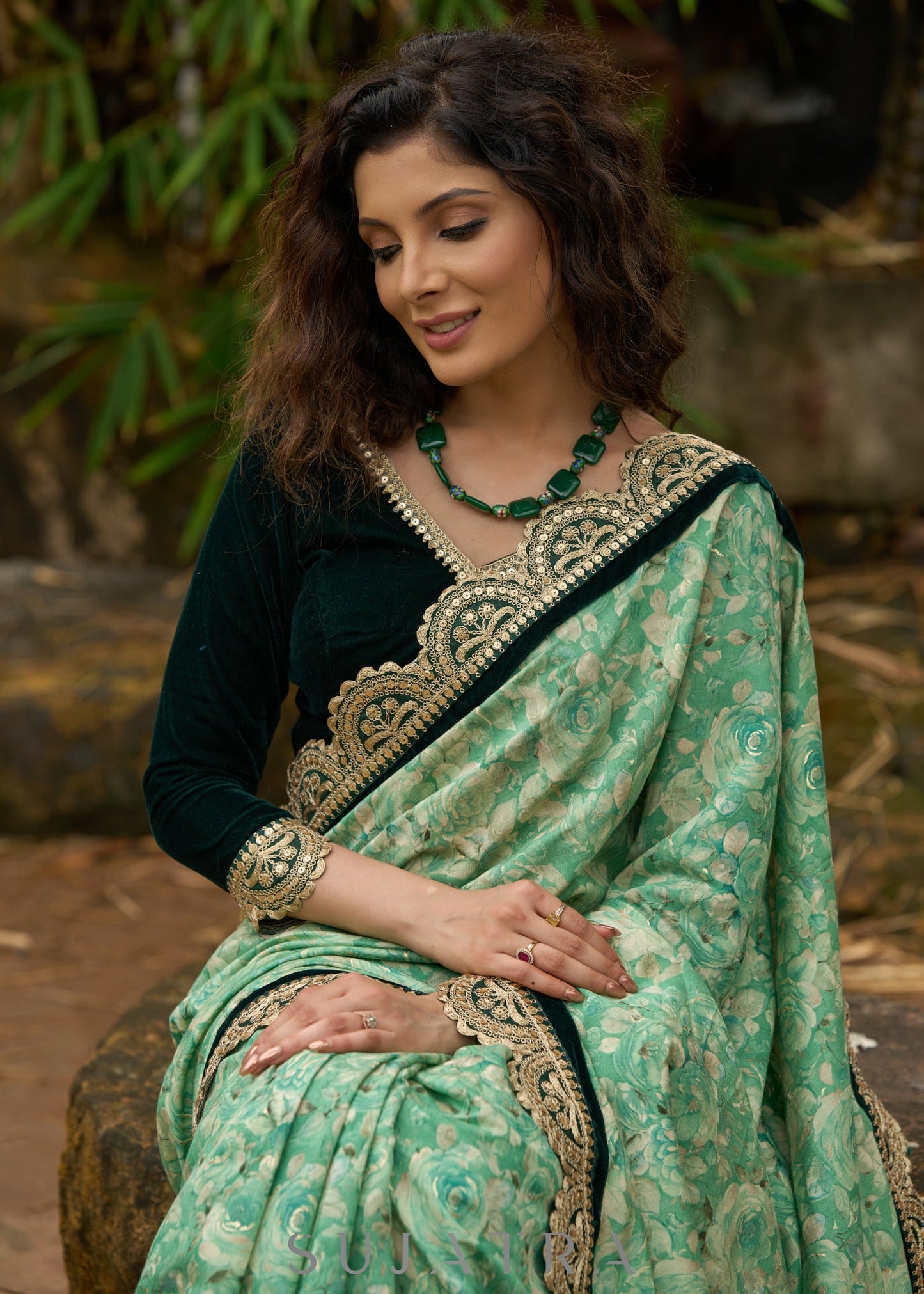 Elegant Emerald green floral printed saree highlighted with bottle green velvet & contrast scalloped lace