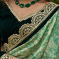 Elegant Emerald green floral printed saree highlighted with bottle green velvet & contrast scalloped lace