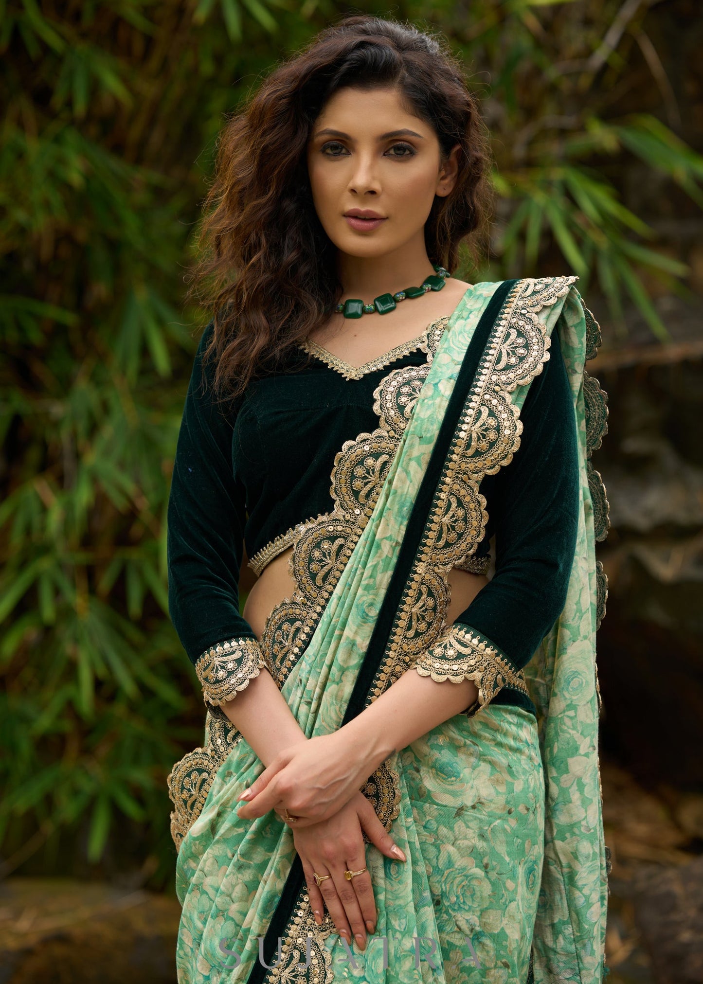 Elegant Emerald green floral printed saree highlighted with bottle green velvet & contrast scalloped lace