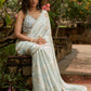 Stylish ice blue floral printed saree highlighted with beautiful golden embroidery