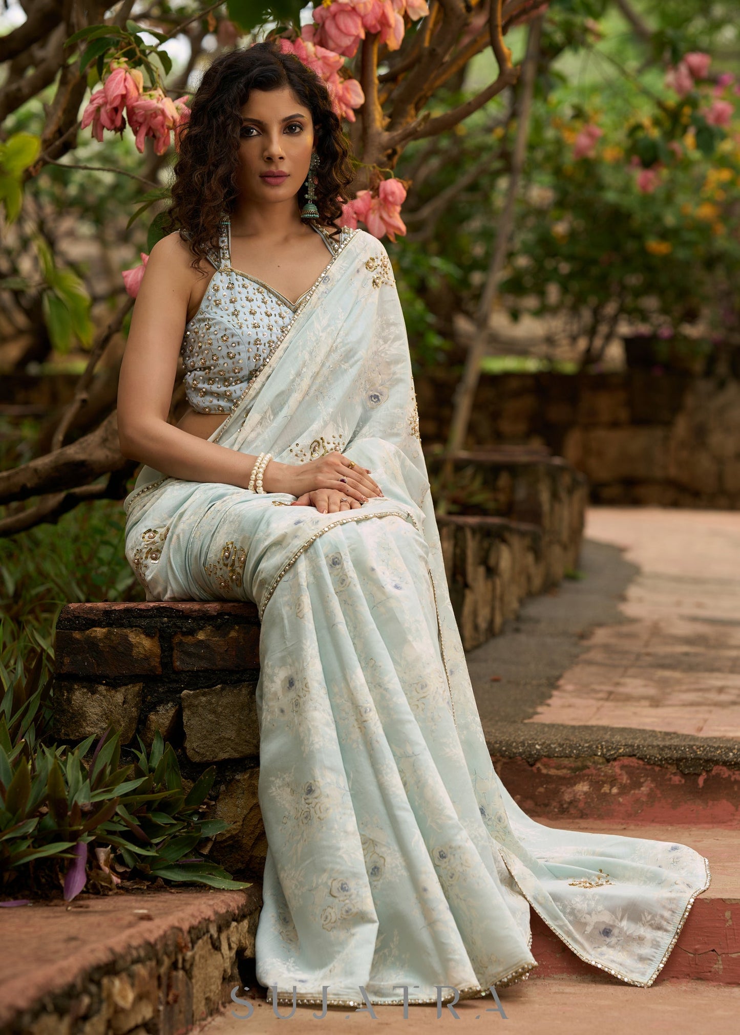 Stylish ice blue floral printed saree highlighted with beautiful golden embroidery