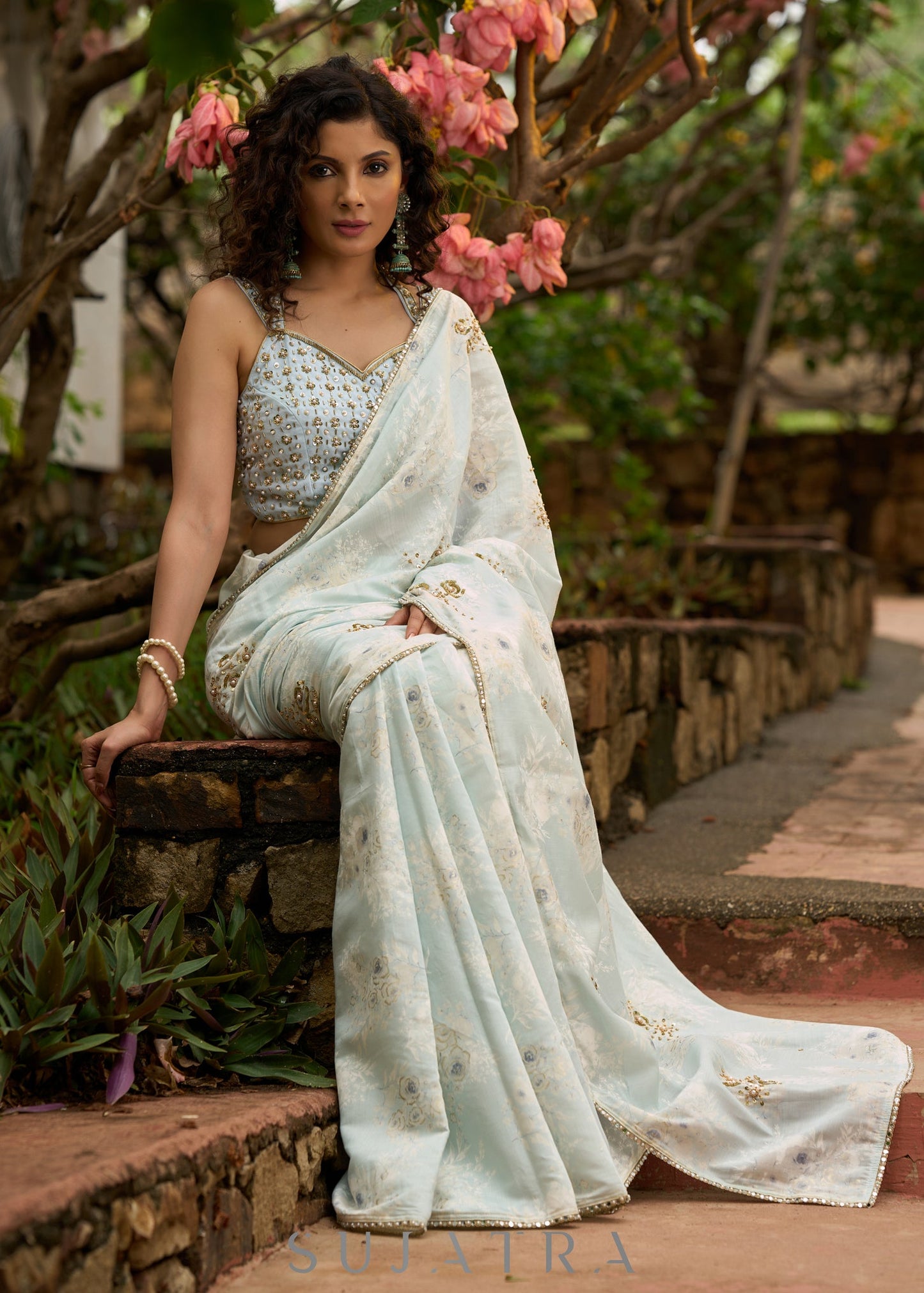 Stylish ice blue floral printed saree highlighted with beautiful golden embroidery