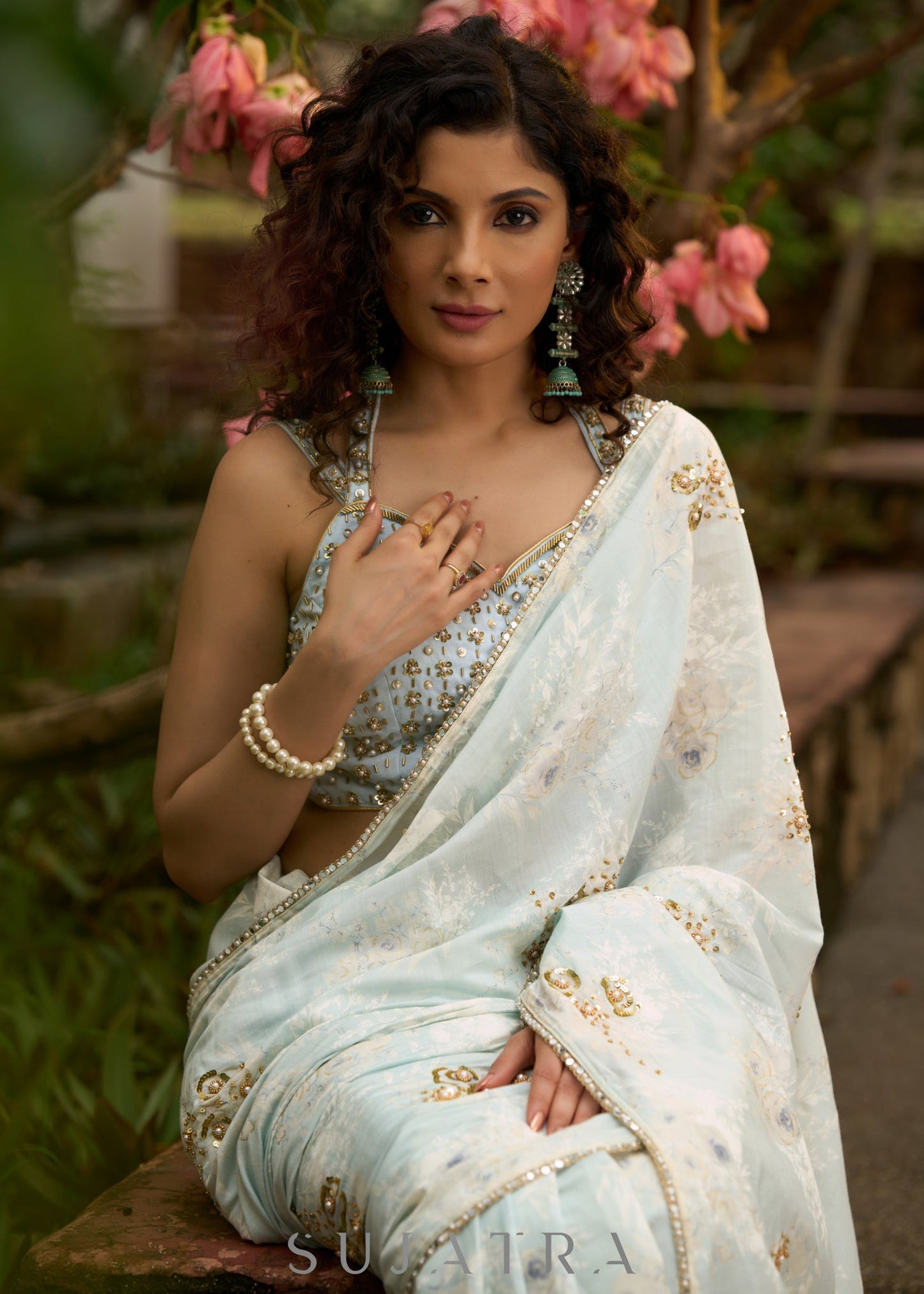 Stylish ice blue floral printed saree highlighted with beautiful golden embroidery