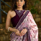 Gracious purple floral printed saree highlighted with velvet pearl embroidered border