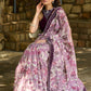 Gracious purple floral printed saree highlighted with velvet pearl embroidered border