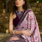 Gracious purple floral printed saree highlighted with velvet pearl embroidered border