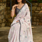 Subtle light pink floral embroidered saree highlighted with overall mirror embroidery and golden lace