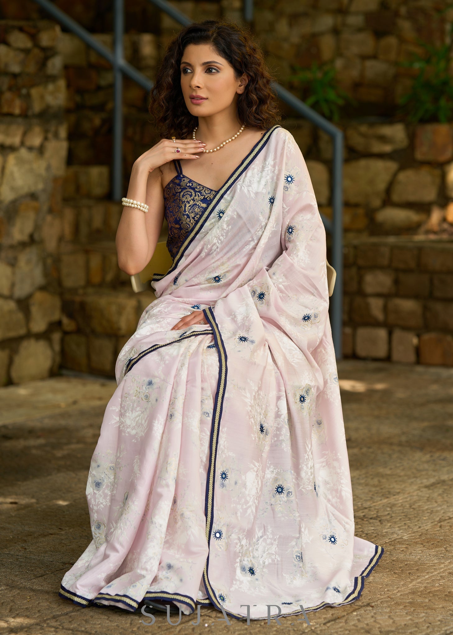 Subtle light pink floral embroidered saree highlighted with overall mirror embroidery and golden lace