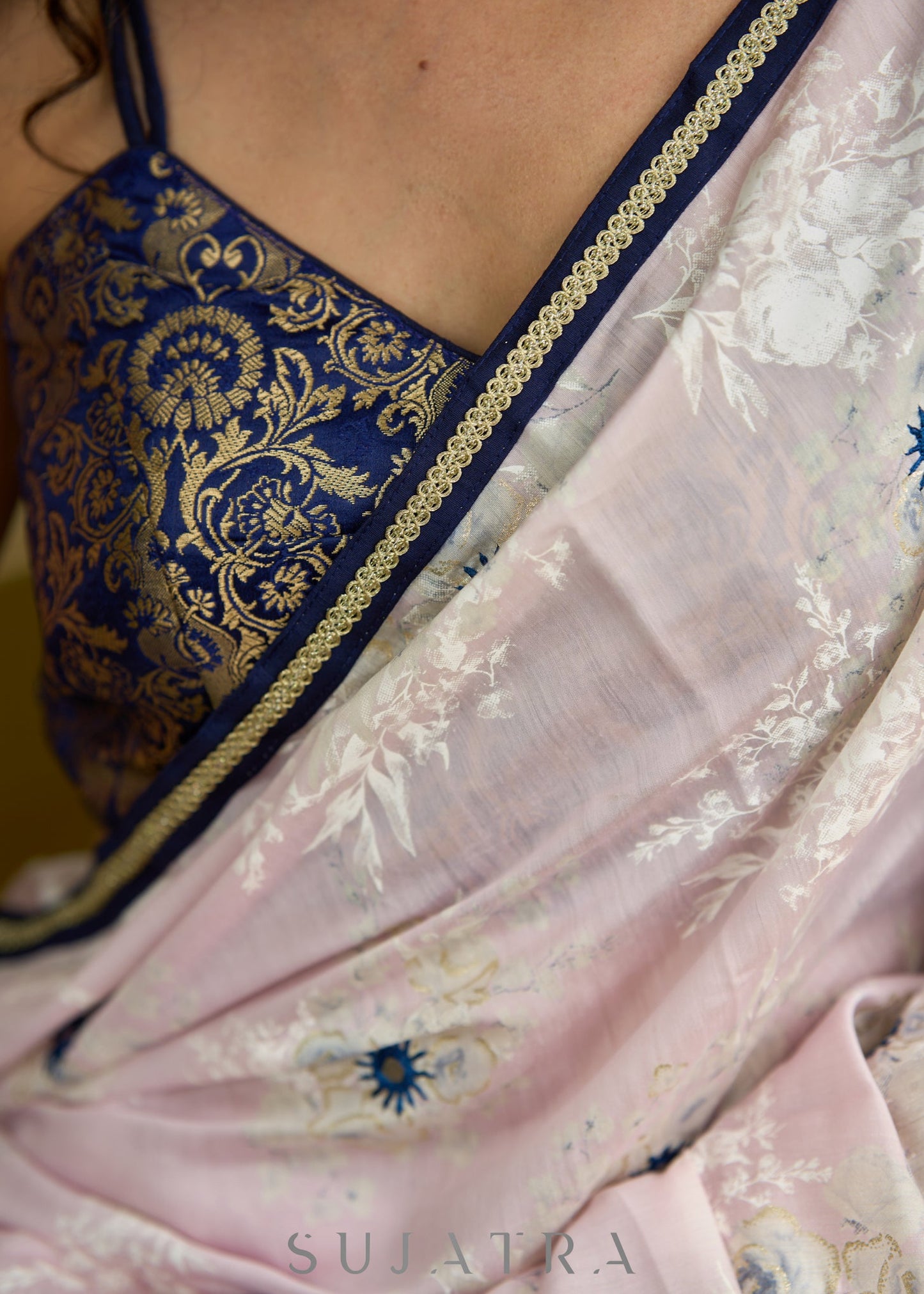 Subtle light pink floral embroidered saree highlighted with overall mirror embroidery and golden lace