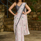 Subtle light pink floral embroidered saree highlighted with overall mirror embroidery and golden lace