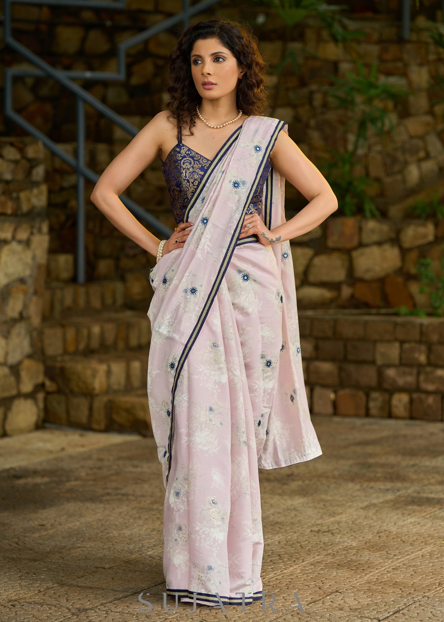 Subtle light pink floral embroidered saree highlighted with overall mirror embroidery and golden lace