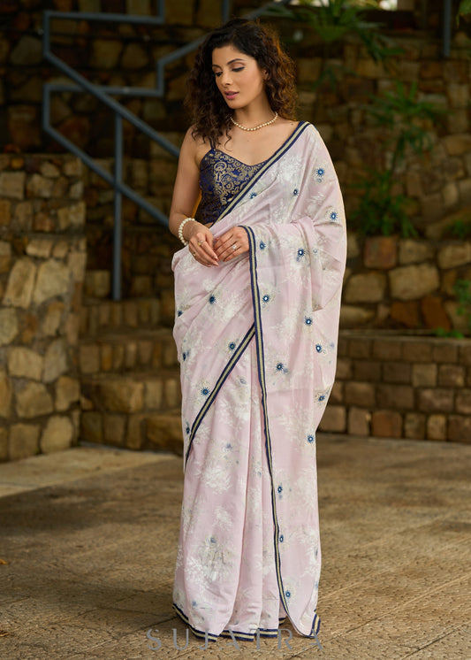 Subtle light pink floral embroidered saree highlighted with overall mirror embroidery and golden lace