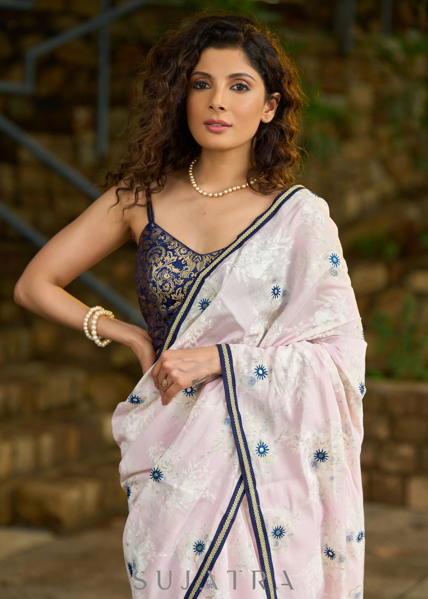 Subtle light pink floral embroidered saree highlighted with overall mirror embroidery and golden lace