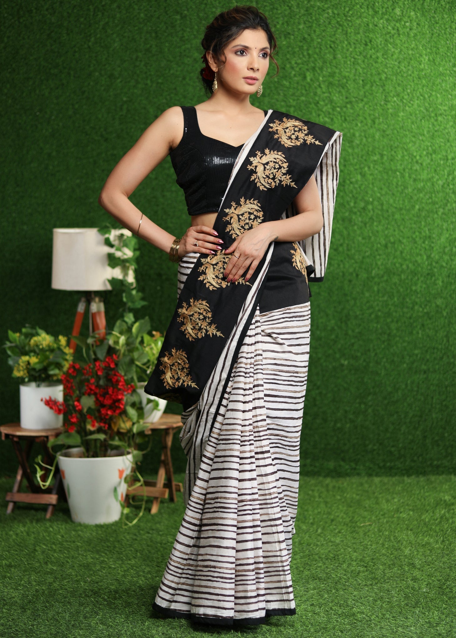 Gorgeous white striped saree with gold embroidered border on pallu