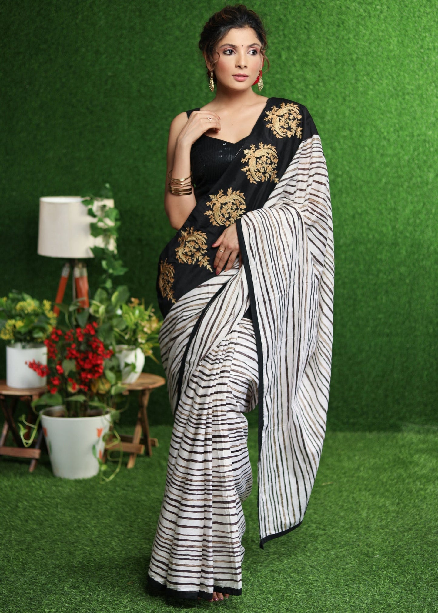 Gorgeous white striped saree with gold embroidered border on pallu