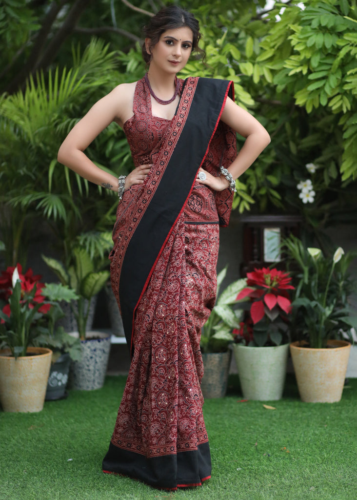 Sensuous maroon Ajrakh saree with black border & Accentuated with stone embellishment