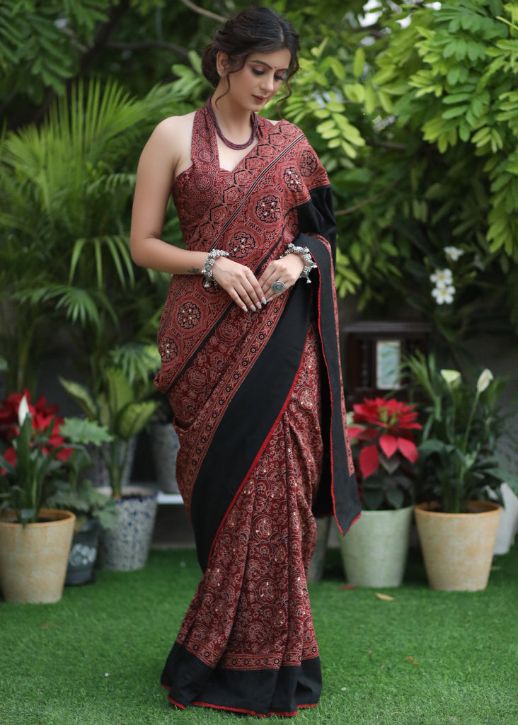 Sensuous maroon Ajrakh saree with black border & Accentuated with stone embellishment