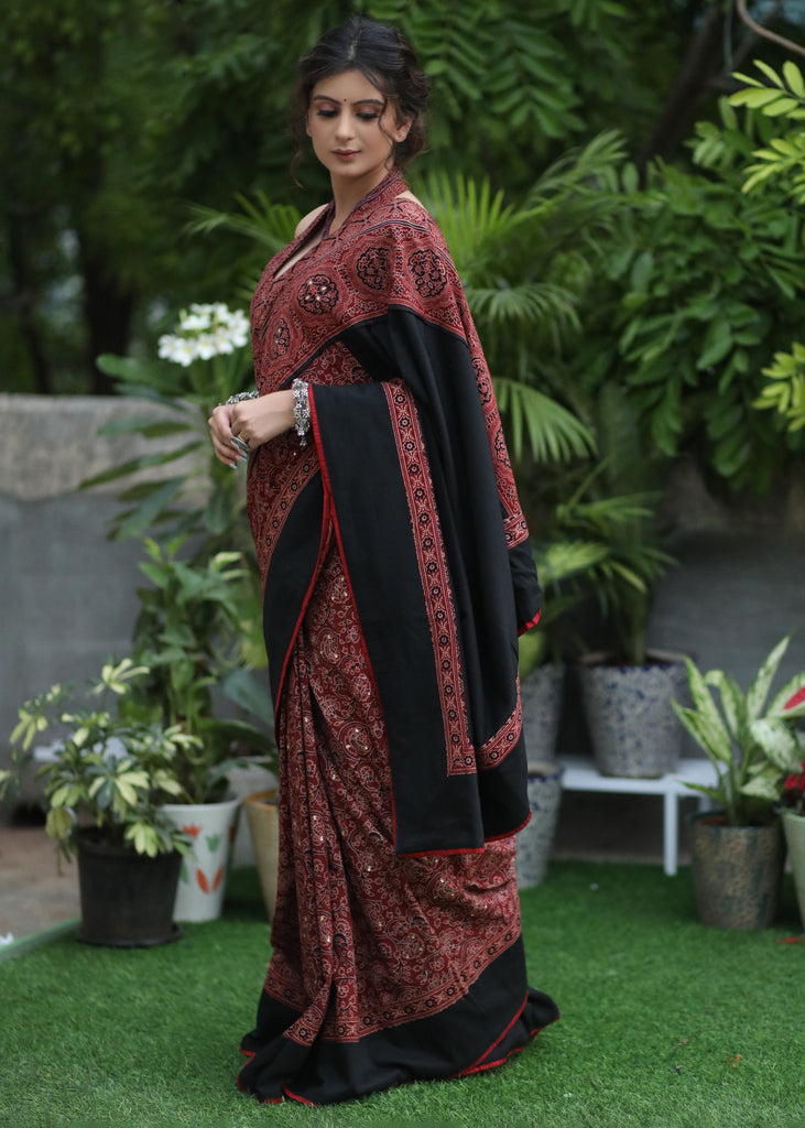 Sensuous maroon Ajrakh saree with black border & Accentuated with stone embellishment