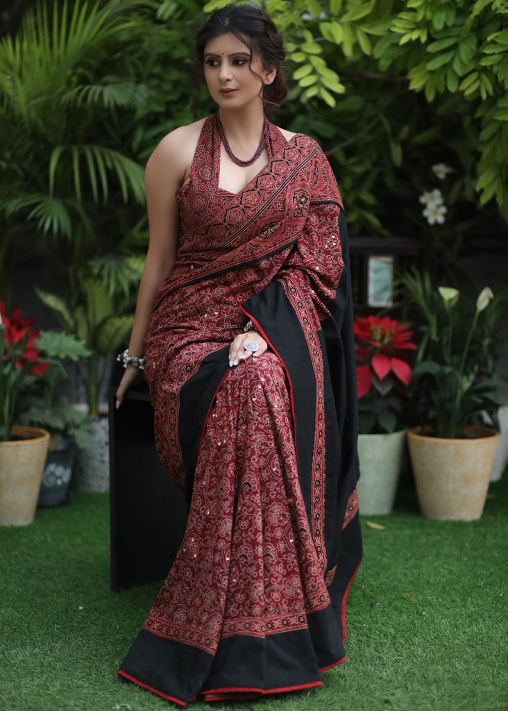 Sensuous maroon Ajrakh saree with black border & Accentuated with stone embellishment