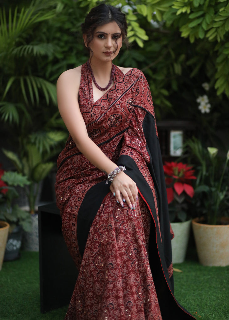 Sensuous maroon Ajrakh saree with black border & Accentuated with stone embellishment