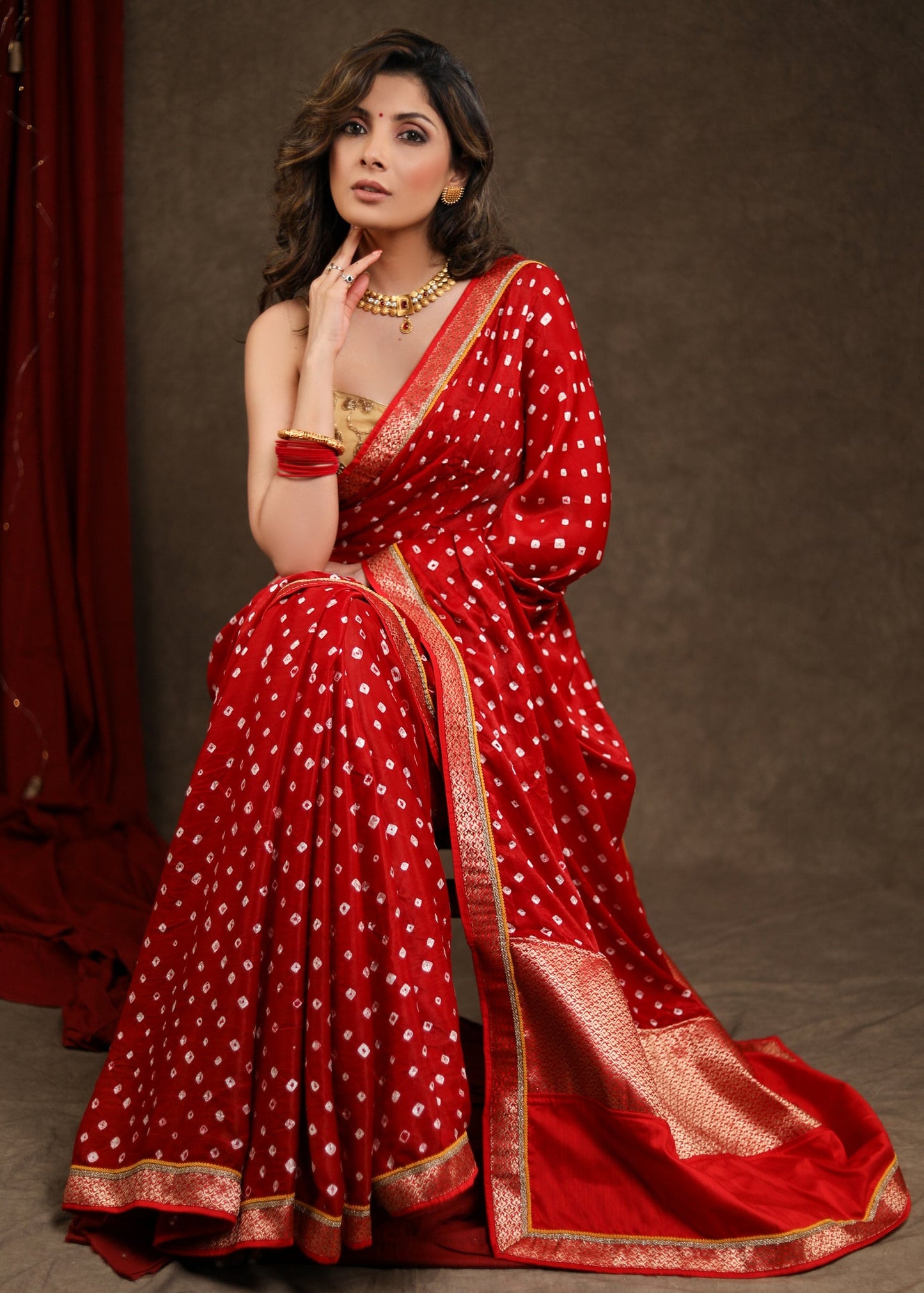 Radiant Red Bandhej Saree with Delicate Gold And Banarasi Detailing